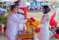Bupati, James Uang, Menyerahkan Bendera Merah Putih Kepada Pembawa Baki Paskibraka